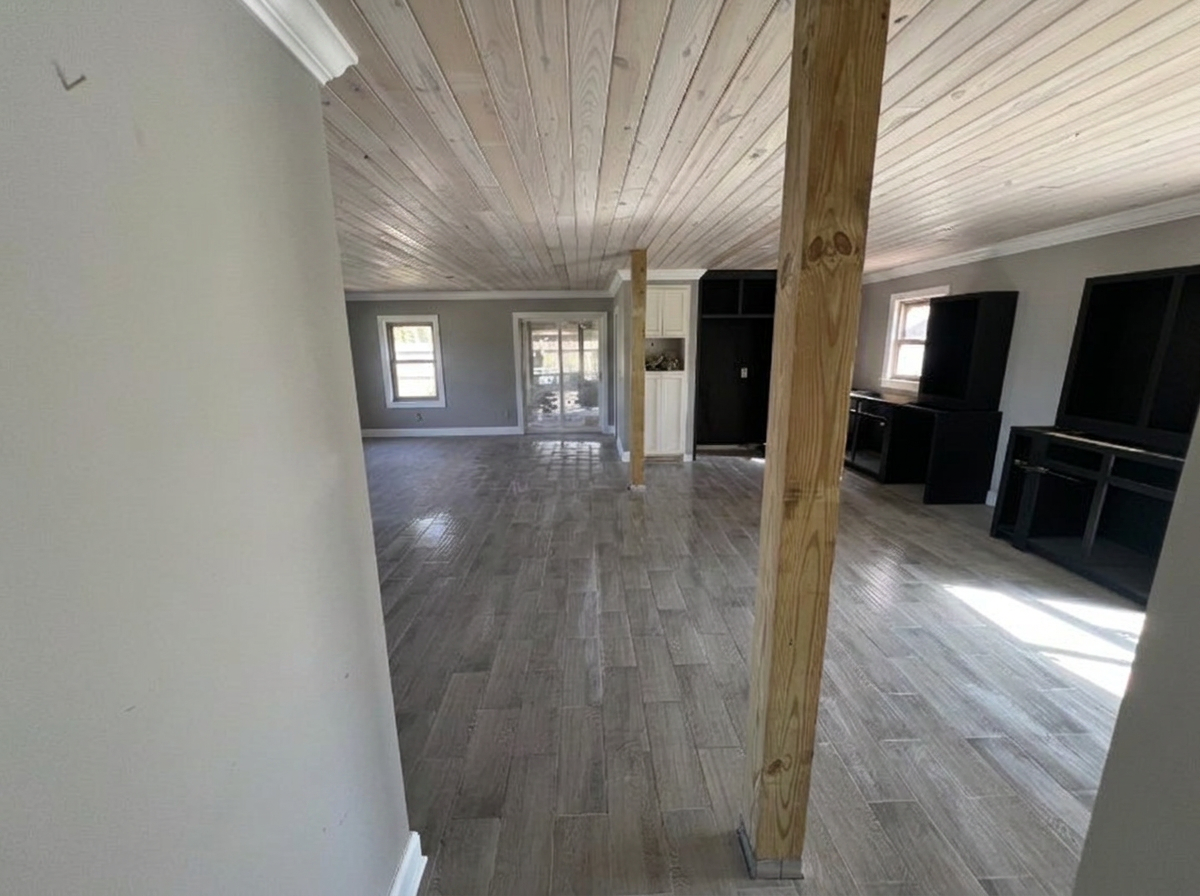 Finished Waverly GA interior with a wood-wrapped structural post, white trim and new plank flooring