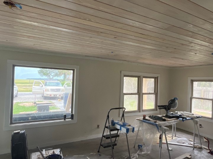 Tongue-and-groove wood plank ceiling being installed over freshly painted walls in the Waverly GA living room